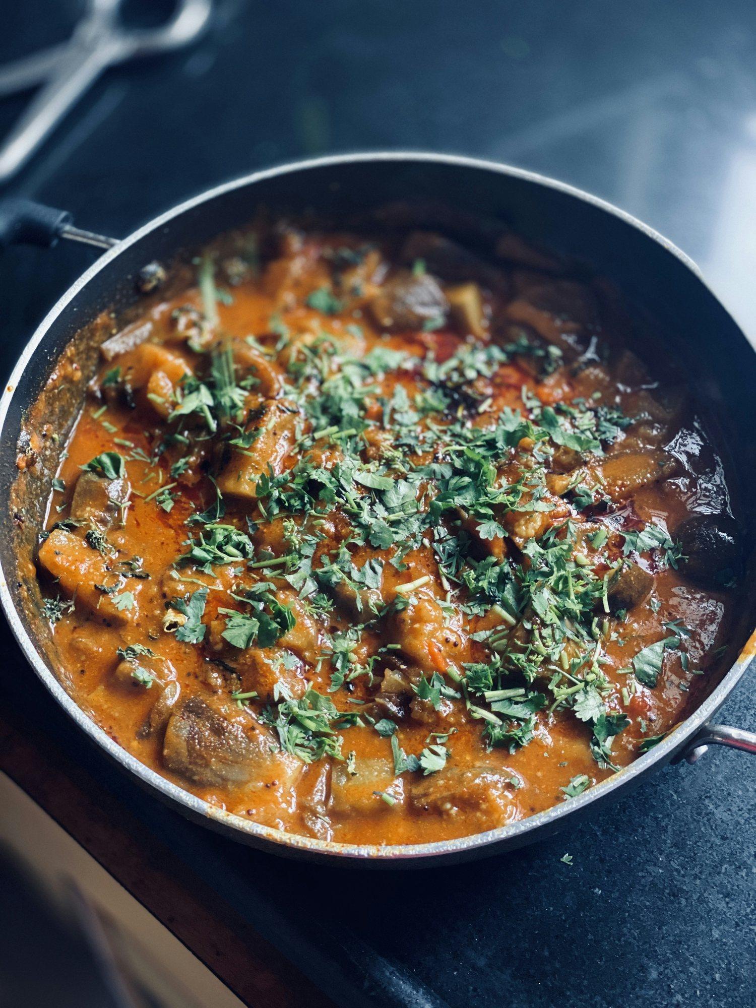 A curry simmering in a pan