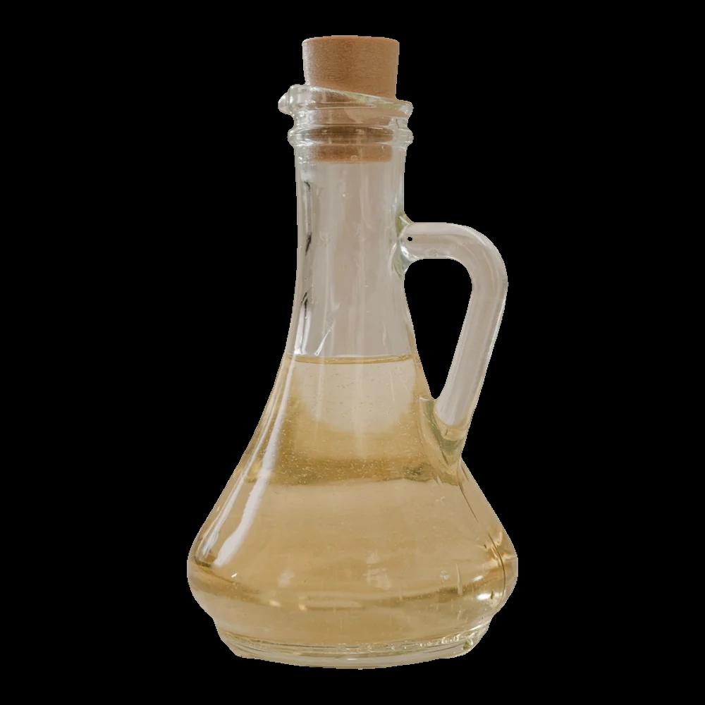 Clear, pale oil in a glass carafe with a cork stopper