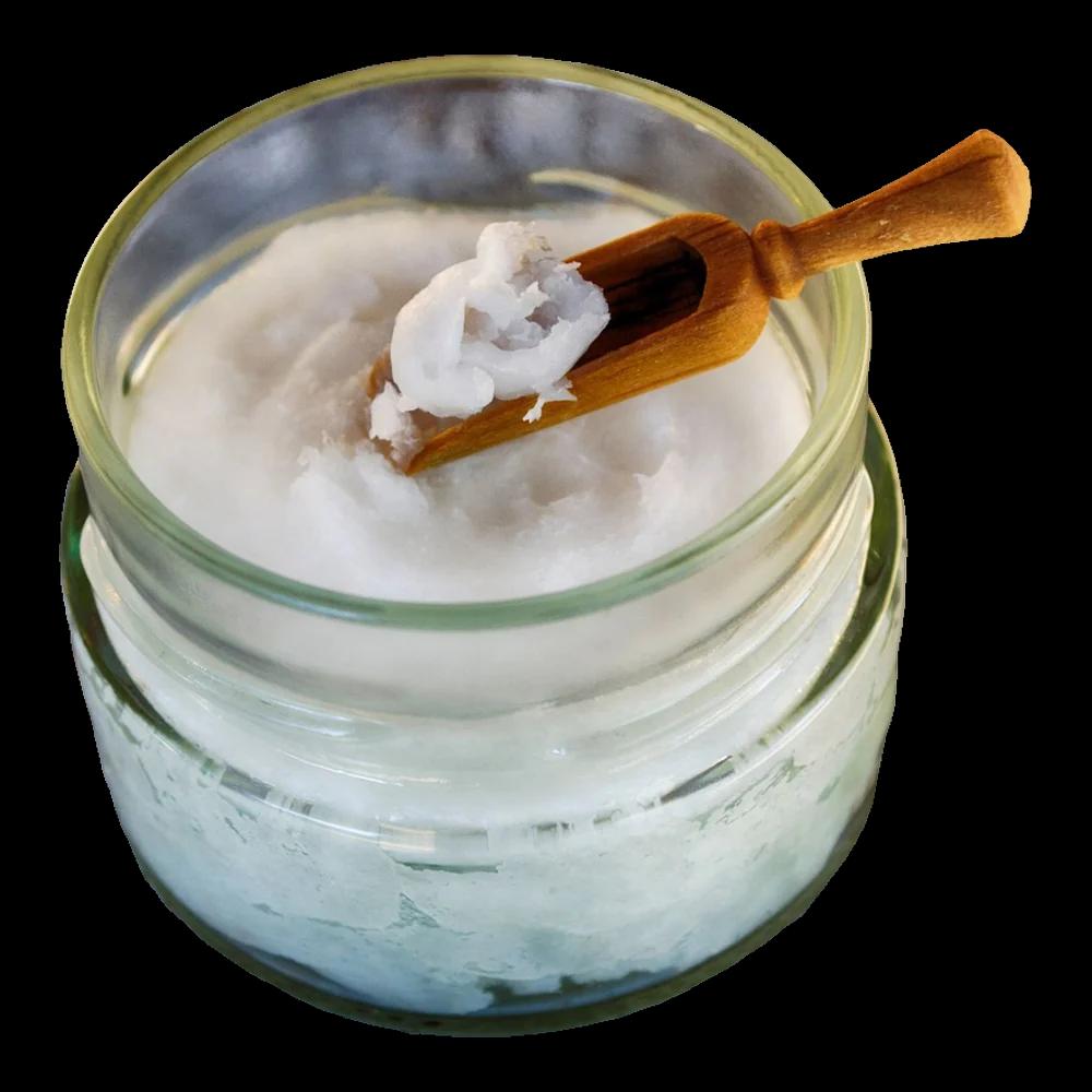 A glass jar of white, set coconut oil with a wooden scoop